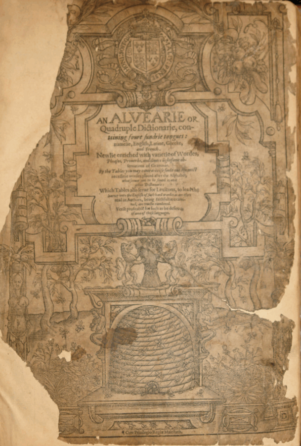 A weathered, ornately illustrated title page of an early printed book titled An Alvearie or Quadruple Dictionarie. The book claims to contain “four sundrie tongues: namelie, English, Latine, Greeke, and French.” Decorative floral and architectural elements frame the text, with a prominent beehive illustration at the bottom center, symbolizing industrious learning. The top features a royal crest. The page shows signs of age, including tears, discoloration, and missing corners.